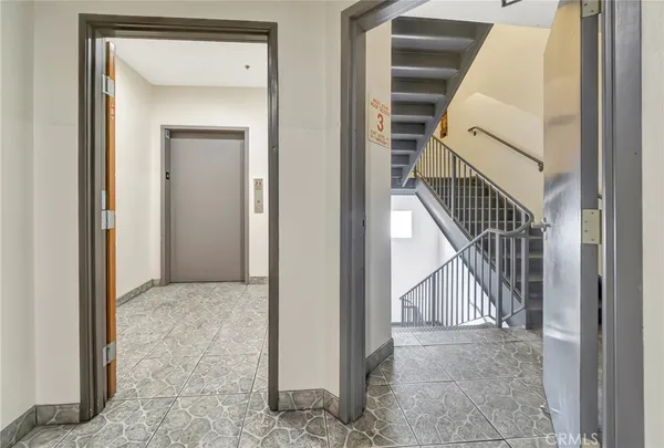 a view of a hallway to rooms and stairs