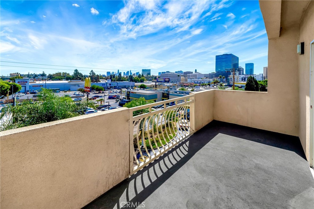 316 South New Hampshire Avenue, Unit 307 Los Angeles, CA 90020 - Photo 22 of 23 a view of a balcony with city view