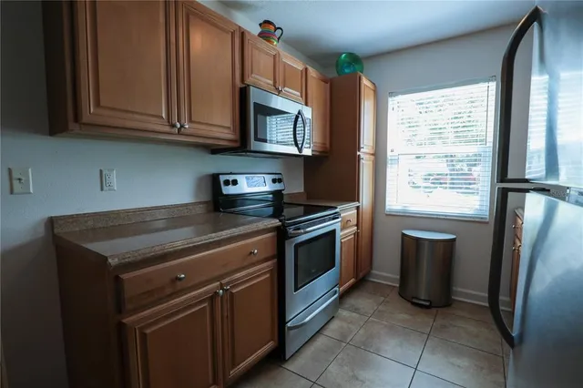 a kitchen with stainless steel appliances granite countertop a refrigerator stove and sink