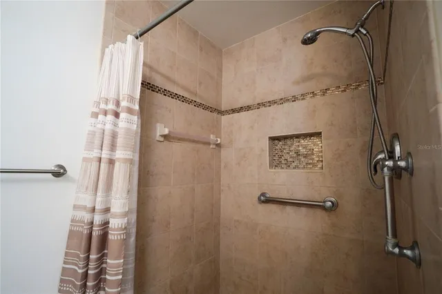 a bathroom with a shower and a glass door