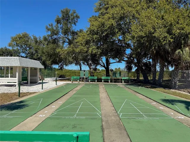 a view of a lake with a yard and large trees