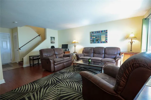 a living room with furniture a couch and a potted plant