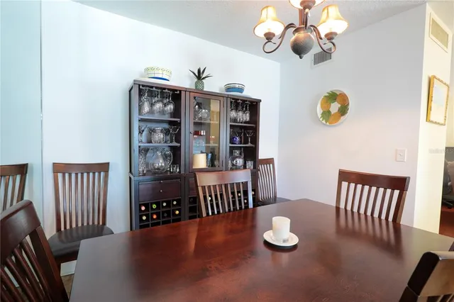 a view of a dining room with furniture wooden floor and chandelier