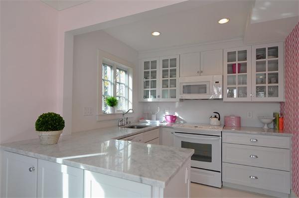 133 Walnut Street Wellesley, MA 02481 - Photo 3 of 12 a kitchen with cabinets a center island and windows