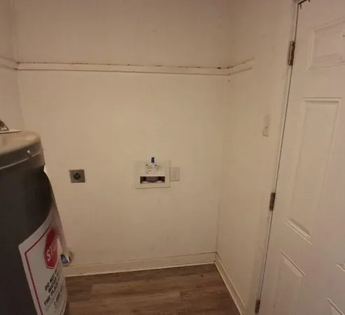 a view of a room with wooden floor