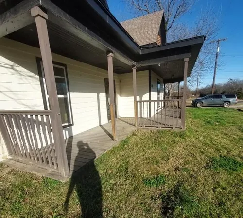 a backyard of a house with a garden and deck