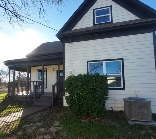a view of a house with backyard and porch