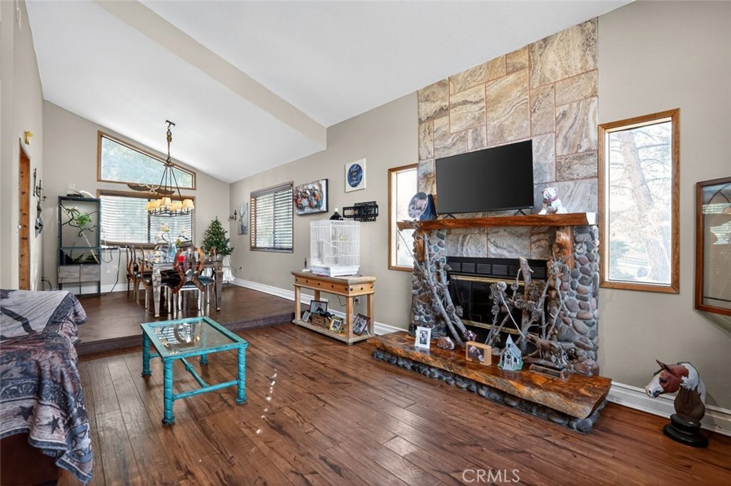 31653 Lake Meadow Road Acton, CA 93510 - Photo 15 of 32 a living room with furniture a flat screen tv and a fireplace