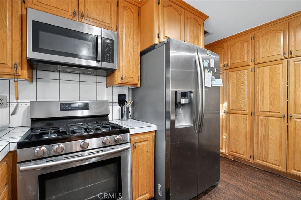 31653 Lake Meadow Road Acton, CA 93510 - Photo 20 of 32 a kitchen with stainless steel appliances granite countertop a refrigerator stove and microwave