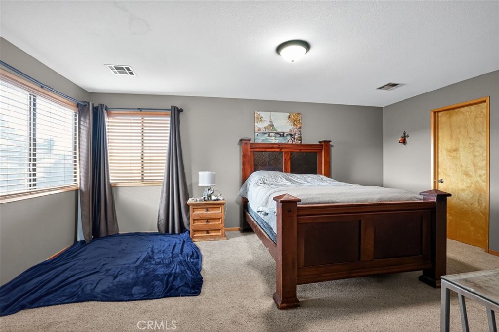 31653 Lake Meadow Road Acton, CA 93510 - Photo 25 of 32 a bedroom with a bed and a window