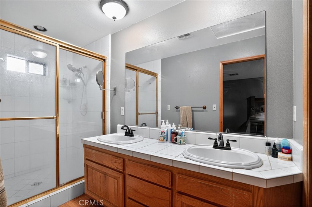 31653 Lake Meadow Road Acton, CA 93510 - Photo 29 of 32 a bathroom with double vanity sinks and a mirror