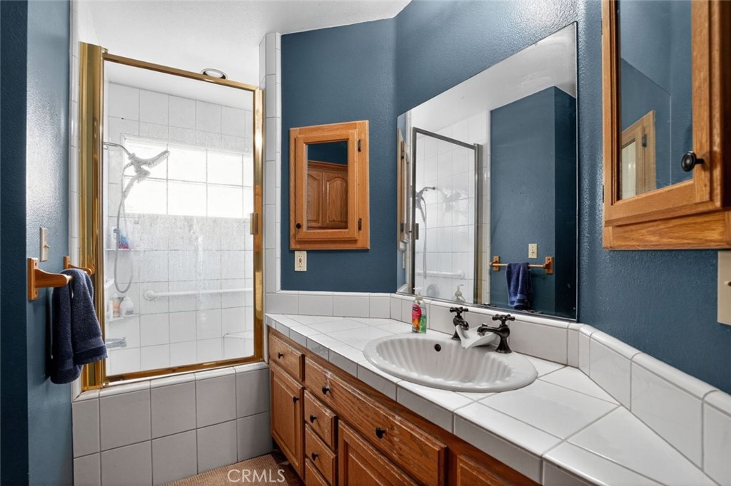 31653 Lake Meadow Road Acton, CA 93510 - Photo 32 of 32 a bathroom with a sink and a mirror