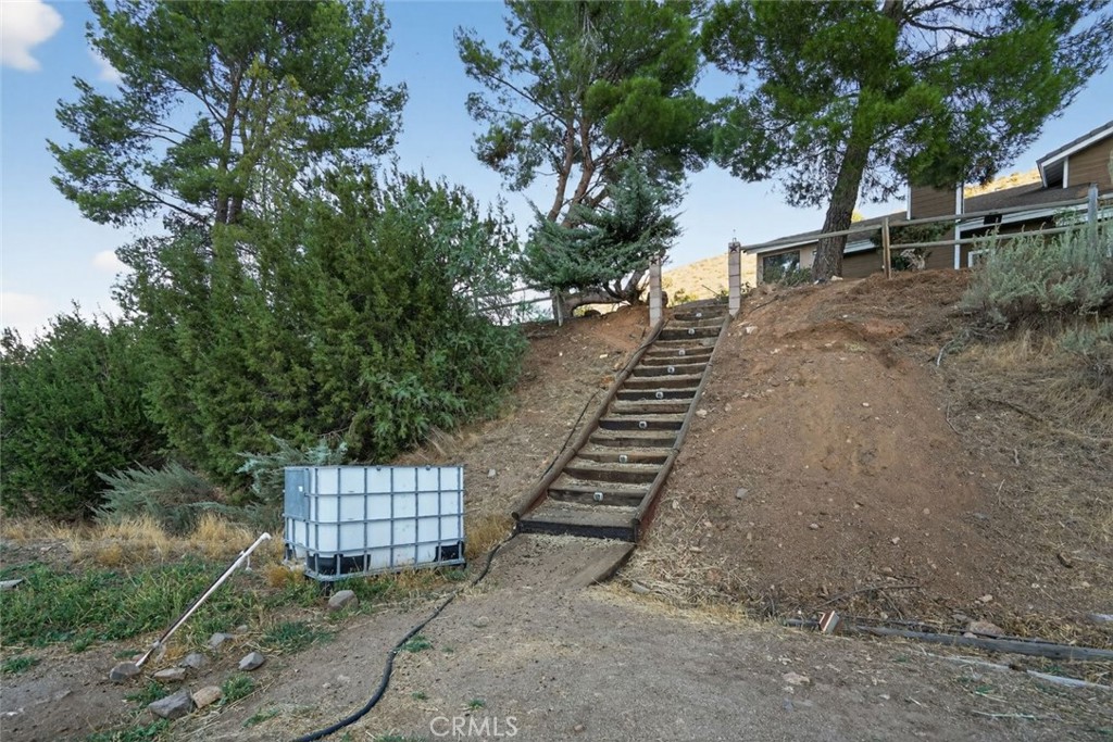 31653 Lake Meadow Road Acton, CA 93510 - Photo 5 of 32 a view of a yard with plants and a bench