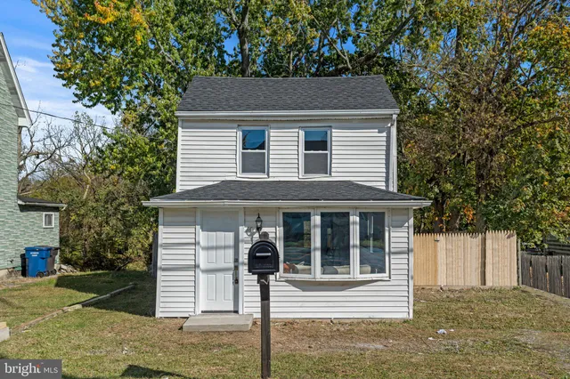 a house that has a tree in front of it