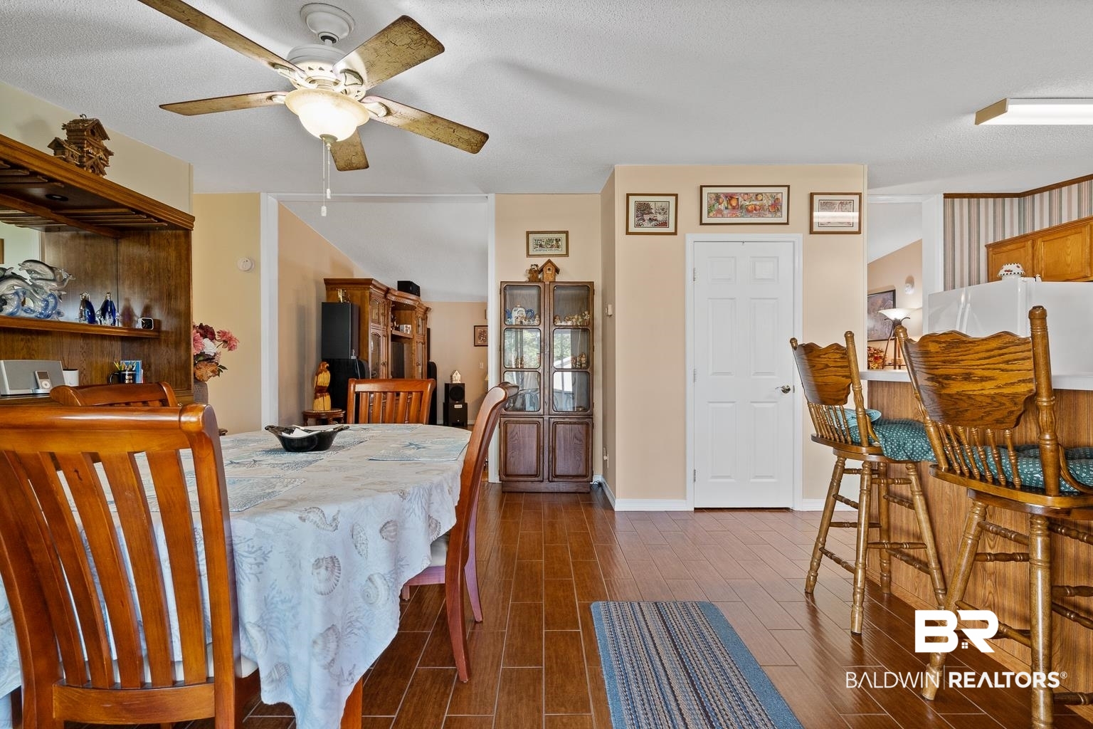 10647 Rte Road Lillian, AL 36549 - Photo 36 of 62 Dining area with baseboards, a ceiling fan, and wood finish floors