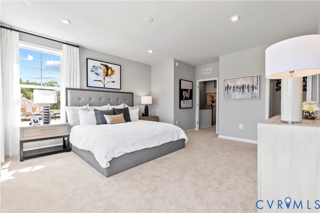 3611 Edna Path, Unit A Richmond, VA 23233 - Photo 14 of 32 a spacious bedroom with a bed and a large mirror