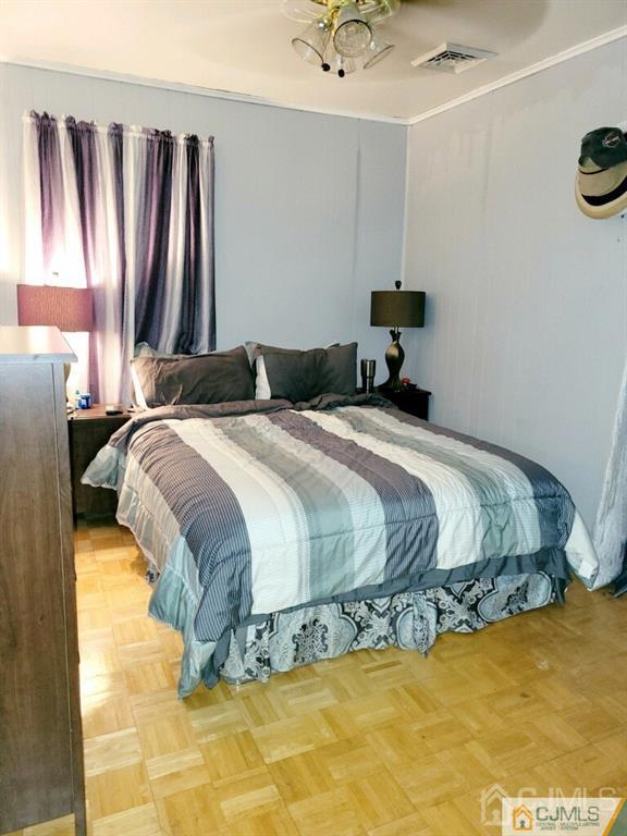 19 Maple Street Parlin, NJ 08859 - Photo 9 of 25 a bedroom with a bed and a chandelier
