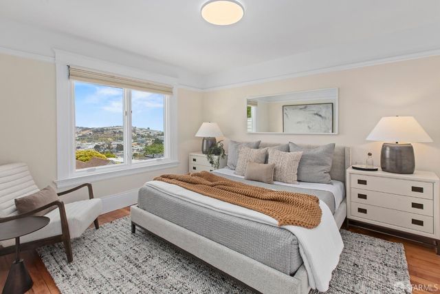 a bed sitting in a bedroom next to a window