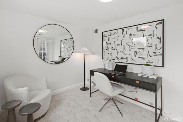 a view of a chair and table in backyard of the house