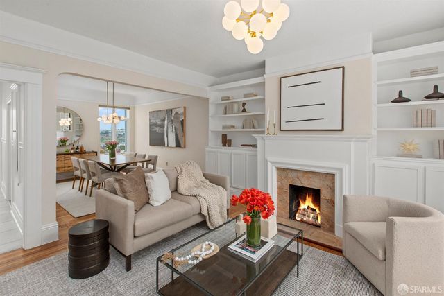 a living room with furniture and a chandelier