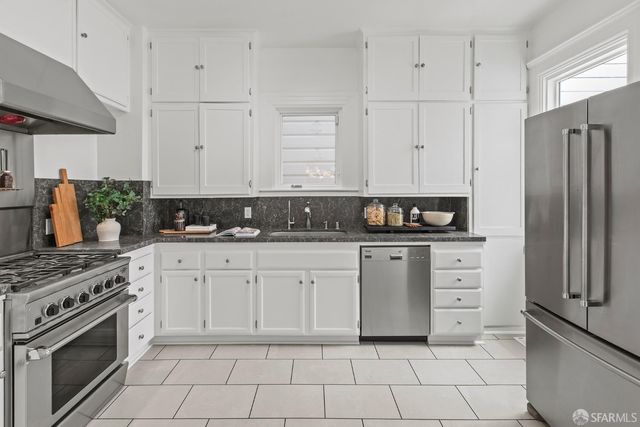 a kitchen with a stove and chairs