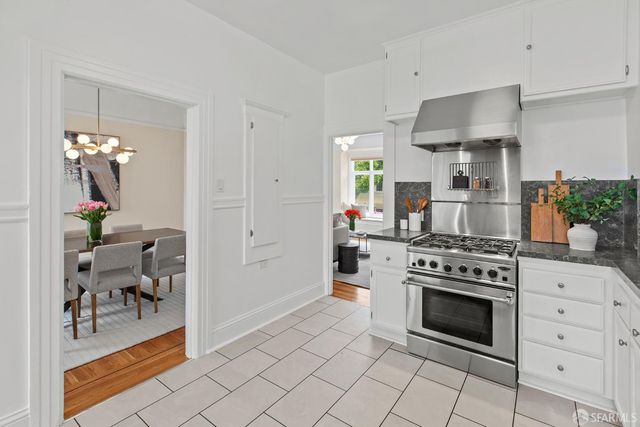 a view of a dining room with furniture a chandelier and wooden floor
