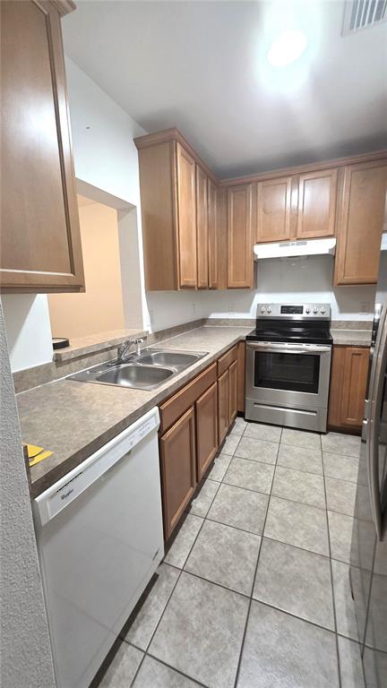 14875 Skip Jack Loop Lakewood Ranch, FL 34202 - Photo 12 of 18 a kitchen with stainless steel appliances granite countertop a stove a sink and a microwave