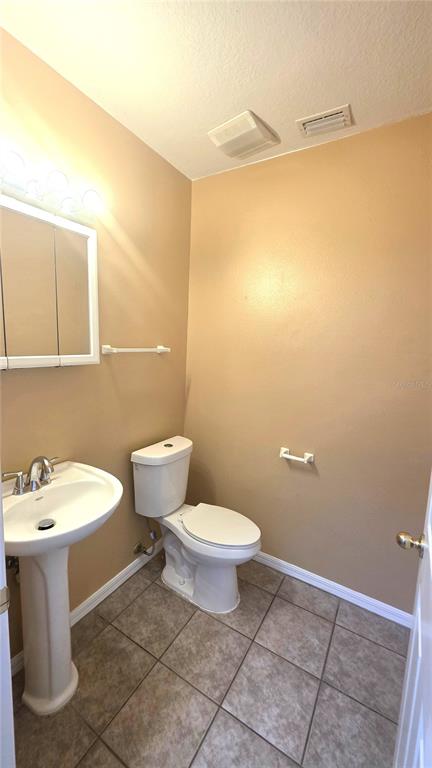 14875 Skip Jack Loop Lakewood Ranch, FL 34202 - Photo 13 of 18 a bathroom with a toilet sink and mirror