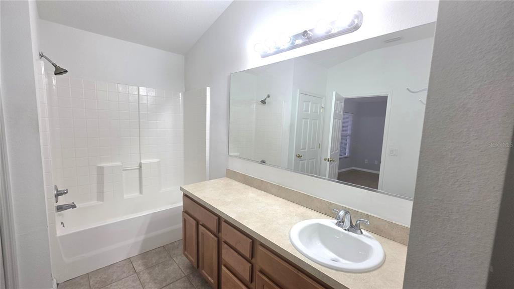 14875 Skip Jack Loop Lakewood Ranch, FL 34202 - Photo 15 of 18 a bathroom with a sink double vanity granite tub shower and a mirror