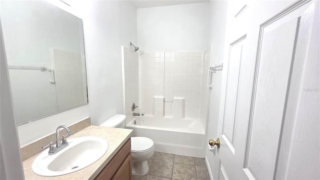 14875 Skip Jack Loop Lakewood Ranch, FL 34202 - Photo 16 of 18 a bathroom with a sink toilet a shower and a mirror