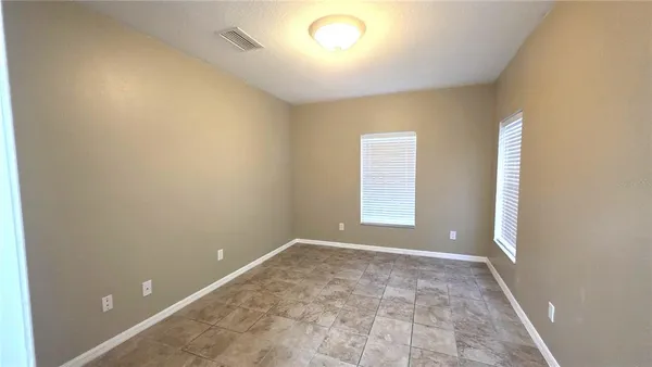 an empty room with a empty space and windows