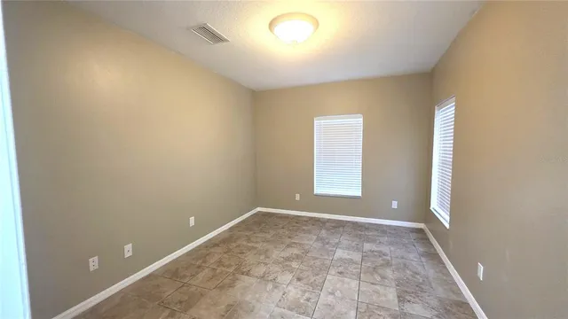 an empty room with a empty space and windows