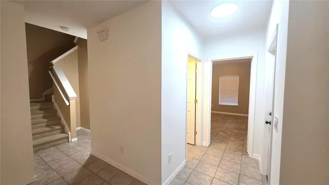 a view of a hallway with wooden floor and entryway