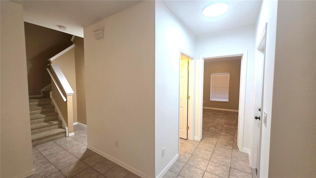 14875 Skip Jack Loop Lakewood Ranch, FL 34202 - Photo 6 of 18 a view of a hallway with wooden floor and entryway