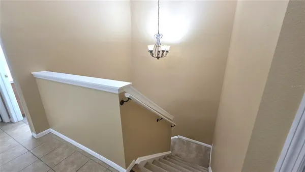 a view of a room with an empty space and a ceiling fan parking space