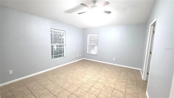 a spacious en suite bathroom with a double vanity sink and mirror with shower