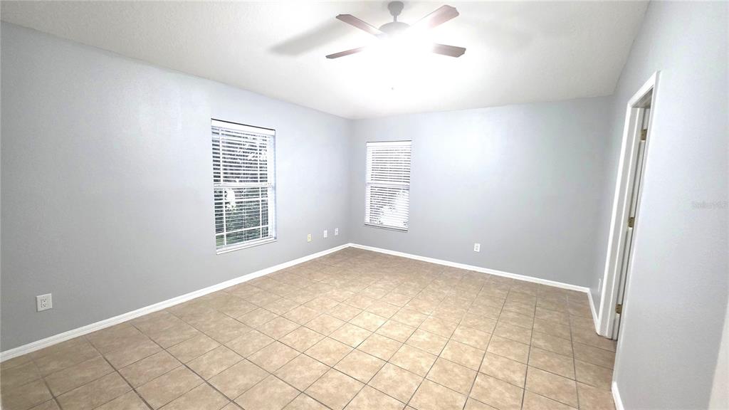 14875 Skip Jack Loop Lakewood Ranch, FL 34202 - Photo 9 of 18 an empty room with windows and fan