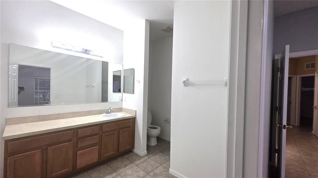 14875 Skip Jack Loop Lakewood Ranch, FL 34202 - Photo 10 of 18 a spacious en suite bathroom with a double vanity sink and mirror with shower