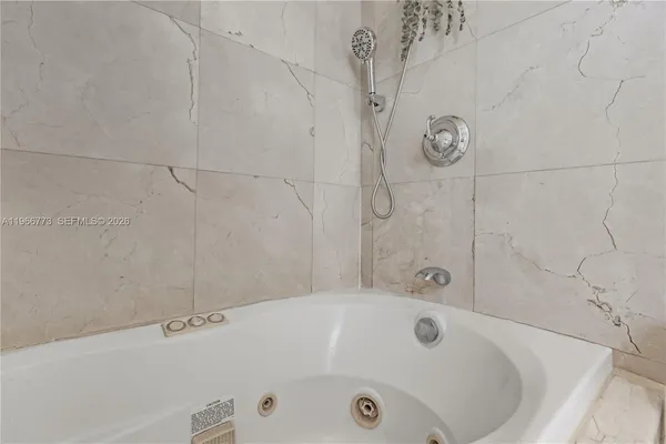 a bathroom with a tub and a shower