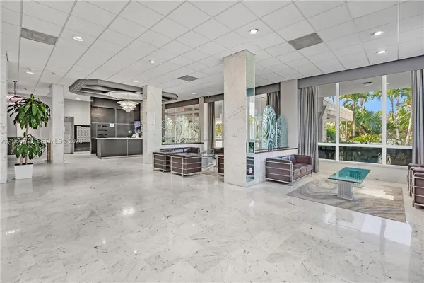 a living room with furniture and large windows