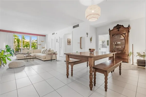a living room with furniture a rug and a chandelier