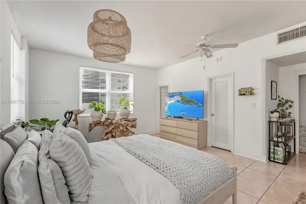 a bed room with a bed mirror and a window