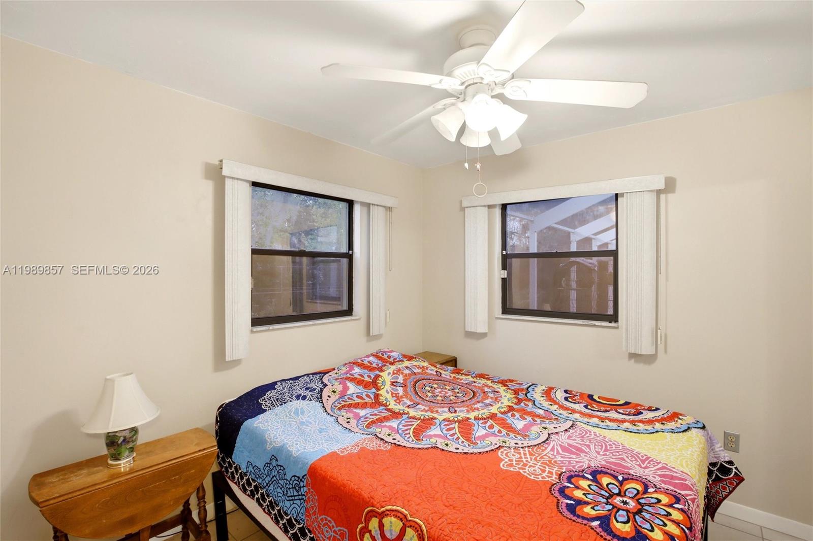 49 Williams Road Lake Placid, FL 33852 - Photo 20 of 61 a bedroom with a bed and a chandelier