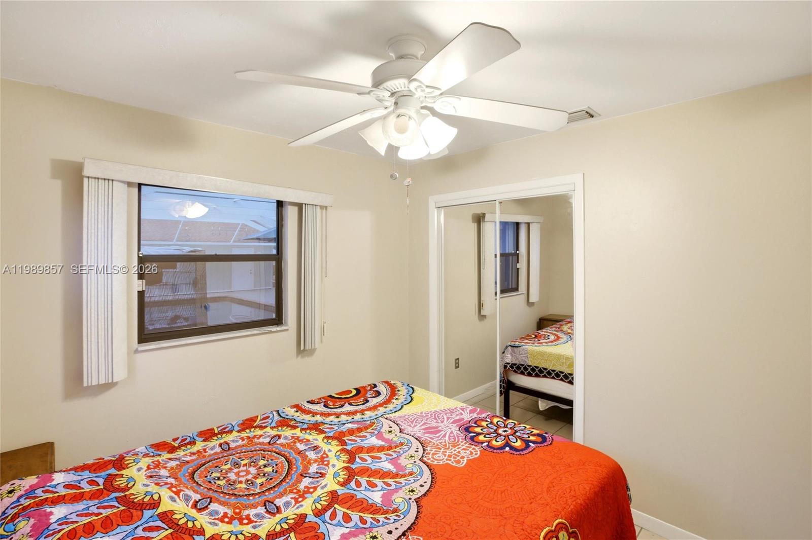 49 Williams Road Lake Placid, FL 33852 - Photo 21 of 61 a bedroom with a bed and a chandelier