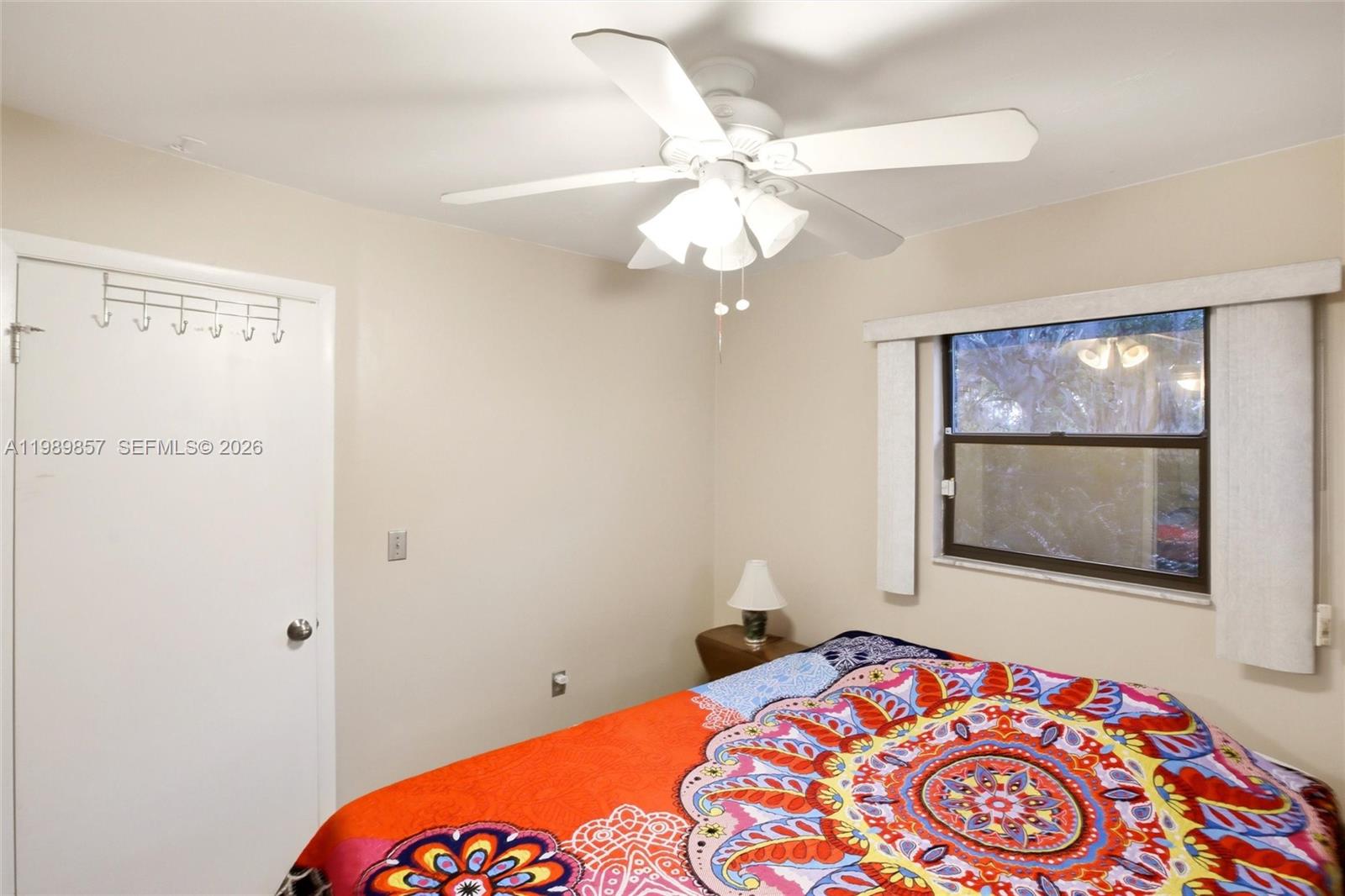 49 Williams Road Lake Placid, FL 33852 - Photo 22 of 61 a bedroom with a bed and a lamp on dresser