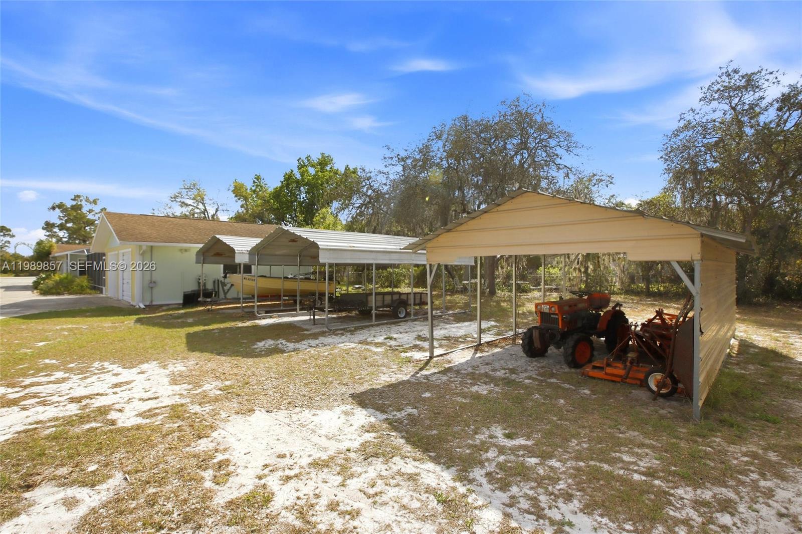 49 Williams Road Lake Placid, FL 33852 - Photo 52 of 61 a backyard of a house with yard and outdoor seating