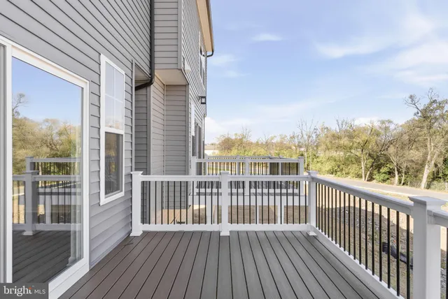 a view of a roof deck with wooden floor and fence
