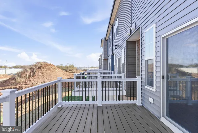 a view of a balcony with wooden floor and fence