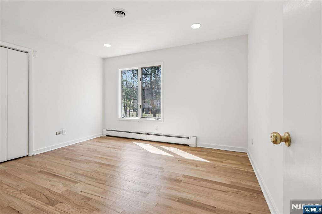 11 Carlough Road Upper Saddle River, NJ 07458 - Photo 33 of 41 an empty room with wooden floor and windows