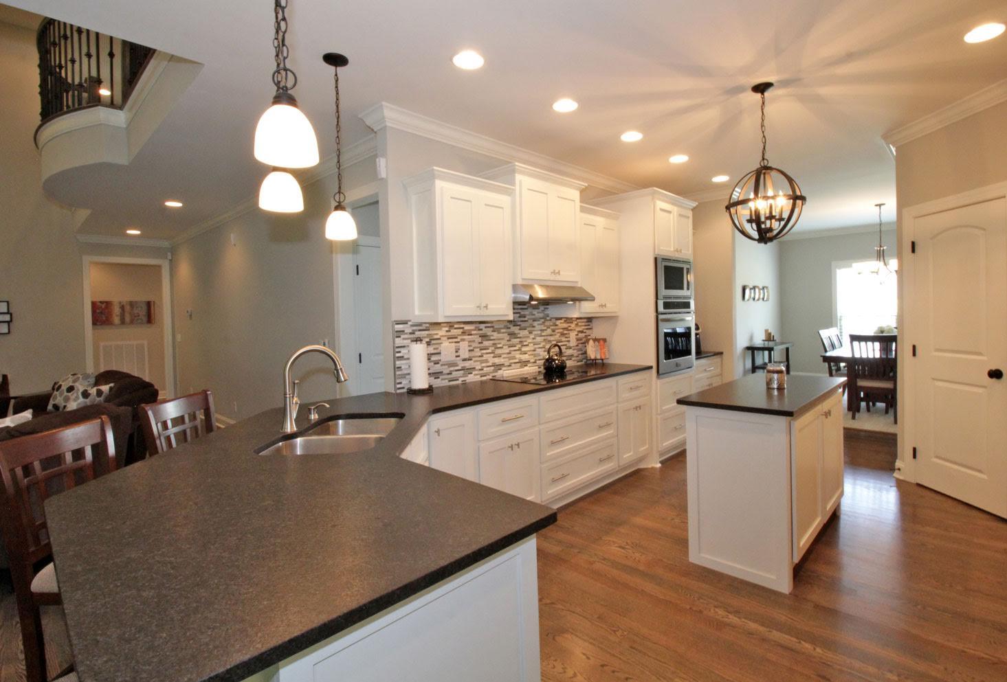 321 Cayce Drive Springfield, TN 37172 - Photo 4 of 30 a large kitchen with kitchen island a large counter space a sink appliances and a living room view